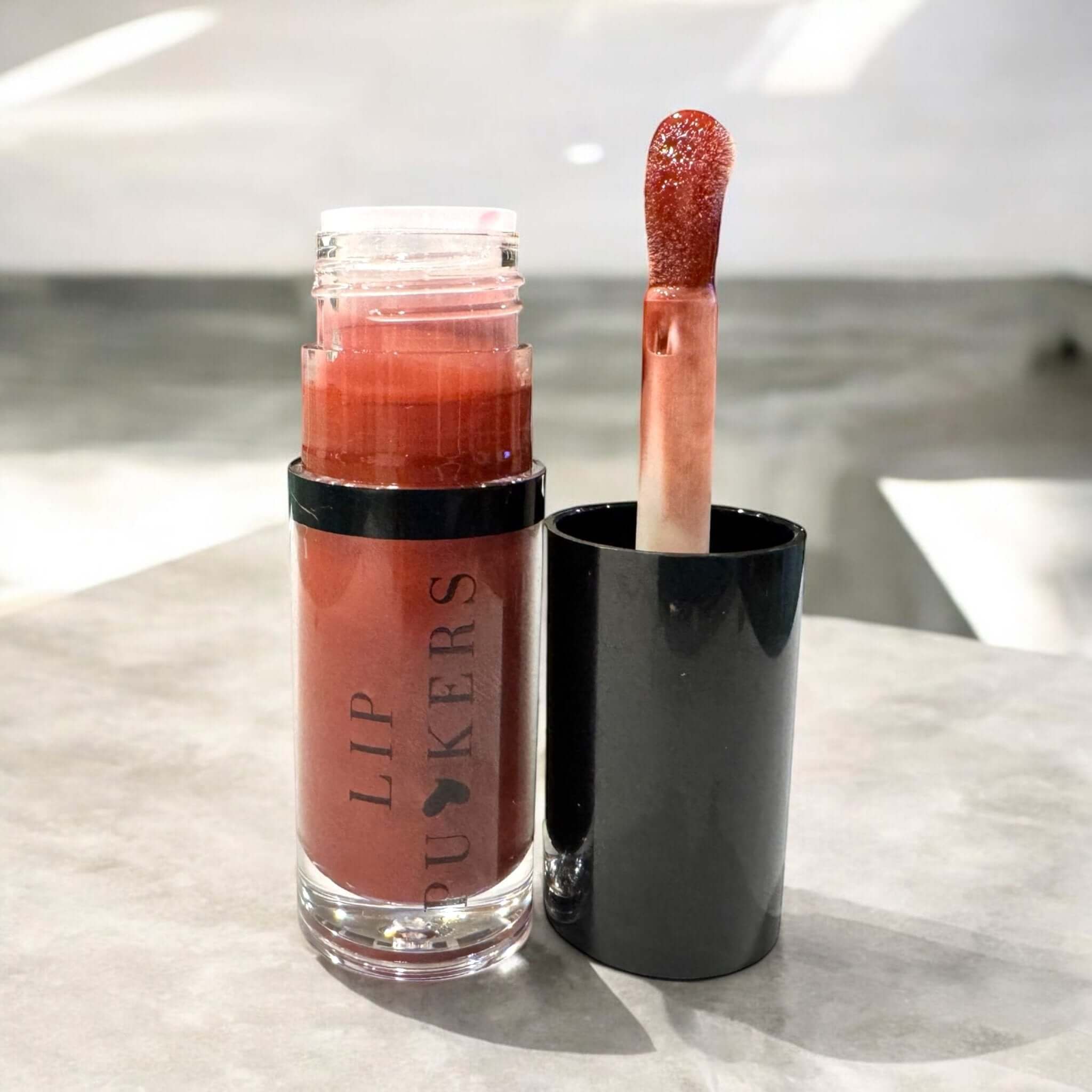 Lip Puckers nourishing lip oil with jojoba, apricot, and vitamin E for glossy, hydrated, and non-greasy lips