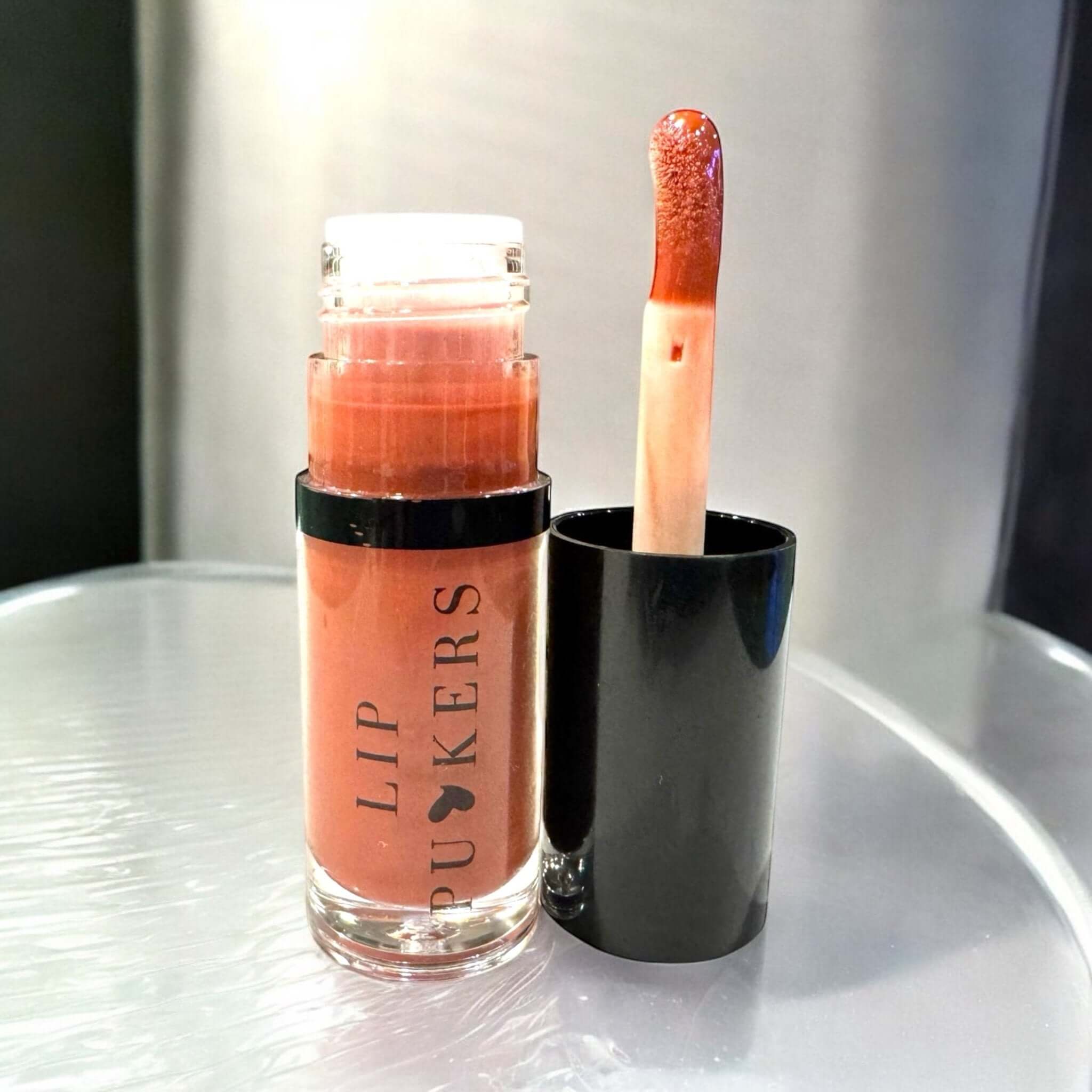 Lip Puckers nourishing lip oil bottle with applicator for glossy, hydrated lips