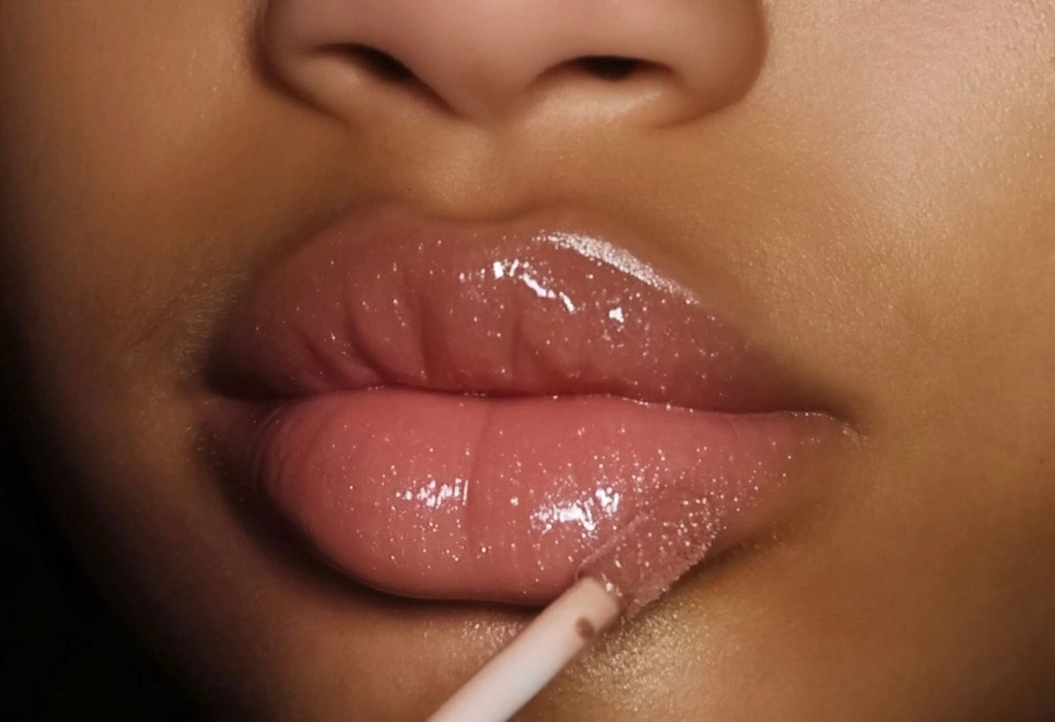 Close-up of lips with velvet luxe gloss application.